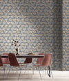 A whimsical, romantic wallpaper, featuring a botanical design in blues, peaches and gold, inspired by Arts and Crafts and Japanese pattern, with a gentle shimmer, in a modern dining room with table and chairs. Wild Lone's "Berry Galaxy" wallpaper in "Smoky Grey".