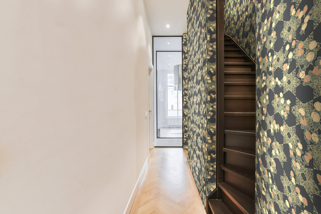 A bold, moody wallpaper featuring a gold and peach, botanical pattern, inspired by Japanese and Arts and Crafts design, against a black background, with a subtle shimmer, in a hallway and stairwell in a bright, modern apartment.