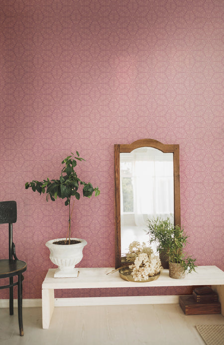 A romantic, pink wallpaper in an intricate, botanical pattern inspired by Japanese and Art Nouveau design, with a subtle pearlescence or shimmer. Wild Lone's "Greenhouse" wallpaper in "Vintage Rose".