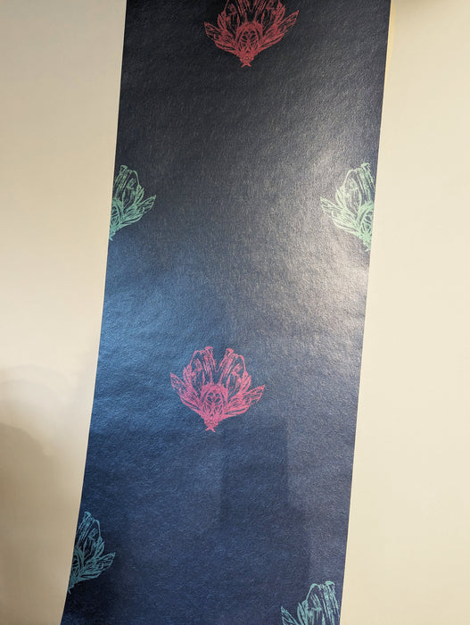 A length of a bold, moody and statement wallpaper, with electric blue and magenta bee forms against a dark blue background, with a shimmery finish. Wild Lone's "Night Flight" wallpaper in "Electric Blue".