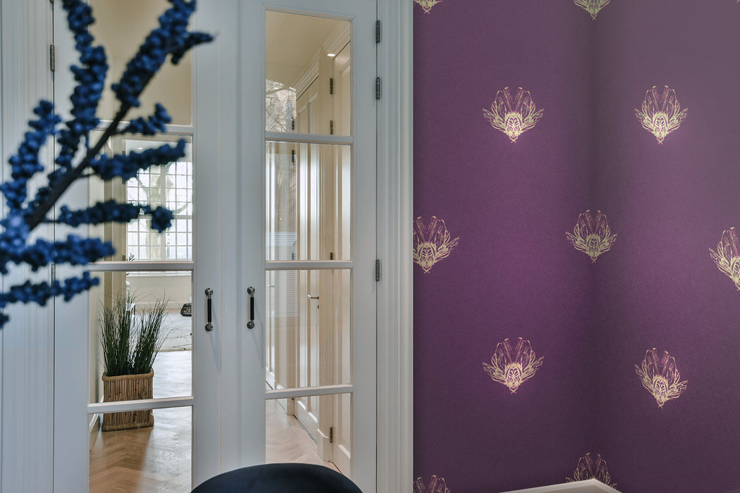 A bold, purple and gold wallpaper in a room with internal double doors, looking into a lit hallway with Georgian Bars. Wild Lone's "Night Flight" wallpaper in "Purple Jewel", featuring fantastical bees in antique gold and magenta, against a purple, pearlescent background. 