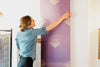 A length of Wild Lone's "Night Flight" wallpaper in "Purple Jewel", a bold and exotic wallpaper, featuring antique gold and magenta bees against a jewel purple background. 