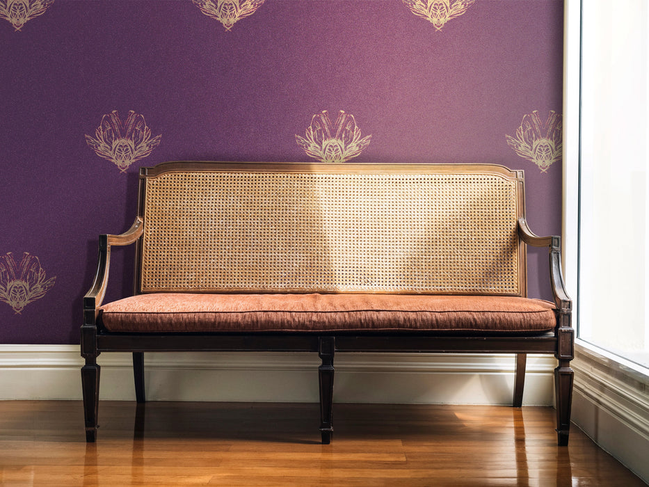 A moody, jewel tone wallpaper featuring fantastical bees, in a period house, in the hallway by a large window with a long, antique, occasional chair with a cane back (Louis XVI style). Wild Lone's "Night Flight" wallpaper in "Purple Jewel", featuring a deep purple background and antique gold and magenta bees.