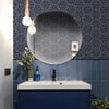 Modern bathroom with exotic, blue and gold wallpaper in an intricate botanical, Art Nouveau and Japanese-inspired design. Wild Lone's "Greenhouse" wallpaper in "Ornamental Blue".